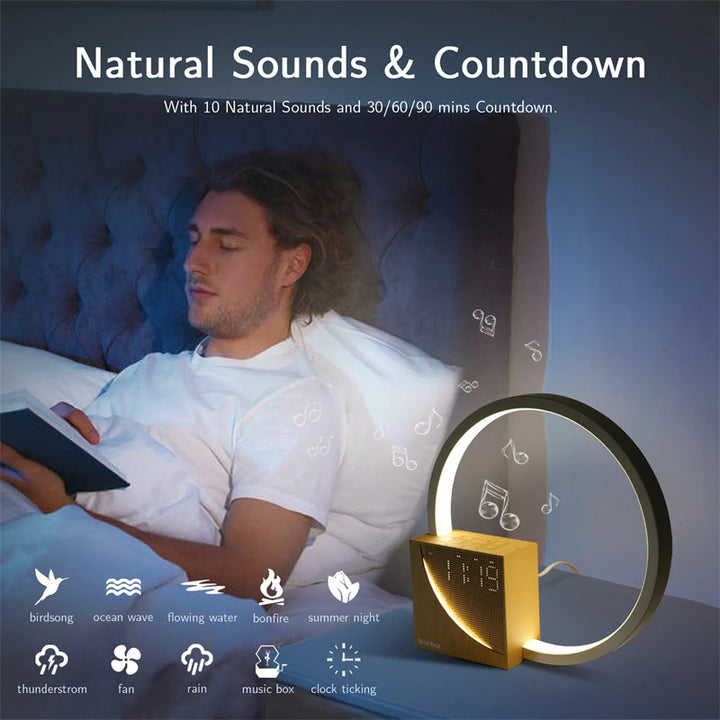 Man sleeping in bed with a clock and lamp displaying natural sounds and countdown features.