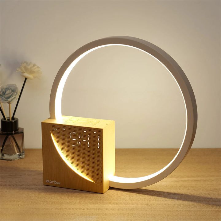 Modern clock with circular light feature on a wooden surface