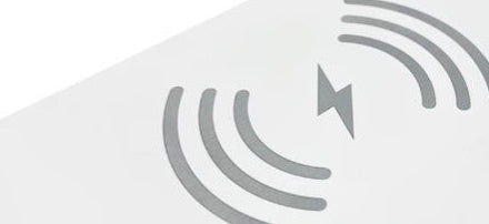Wireless charging pad with circular induction field symbol on a white background